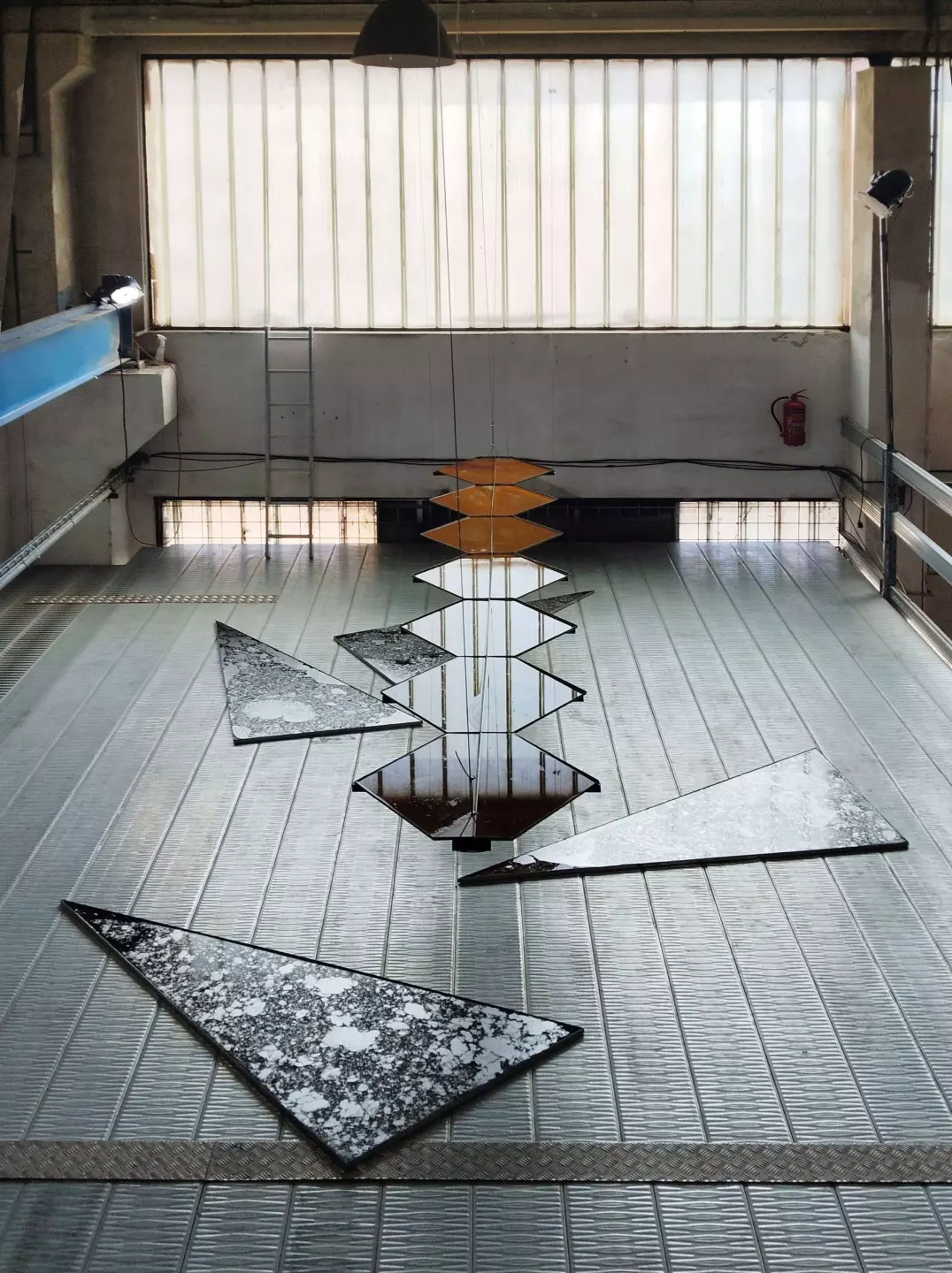 Céline Struger, Transverse Orientation, 2025, steel, water, 7 × 90 × 580 cm